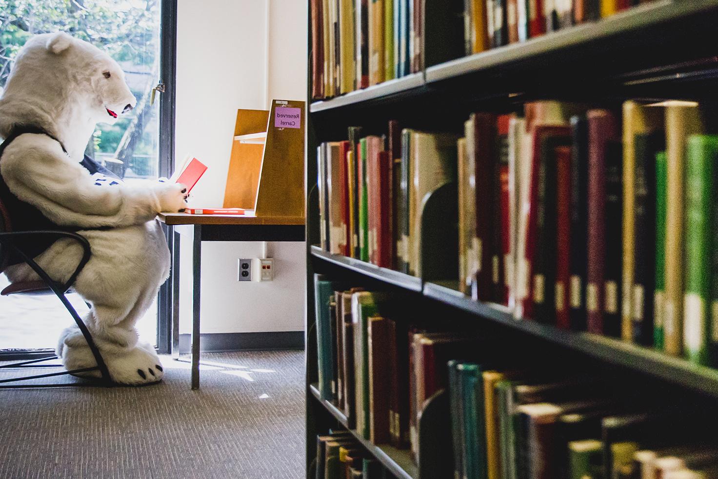 Polar bear mascot reading